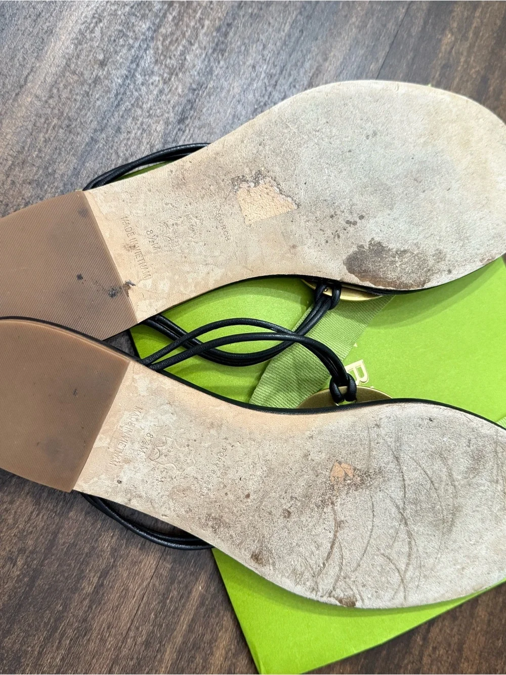 Tory Burch Patos Disk Leather Thong Sandals in black with gold-tone medallions